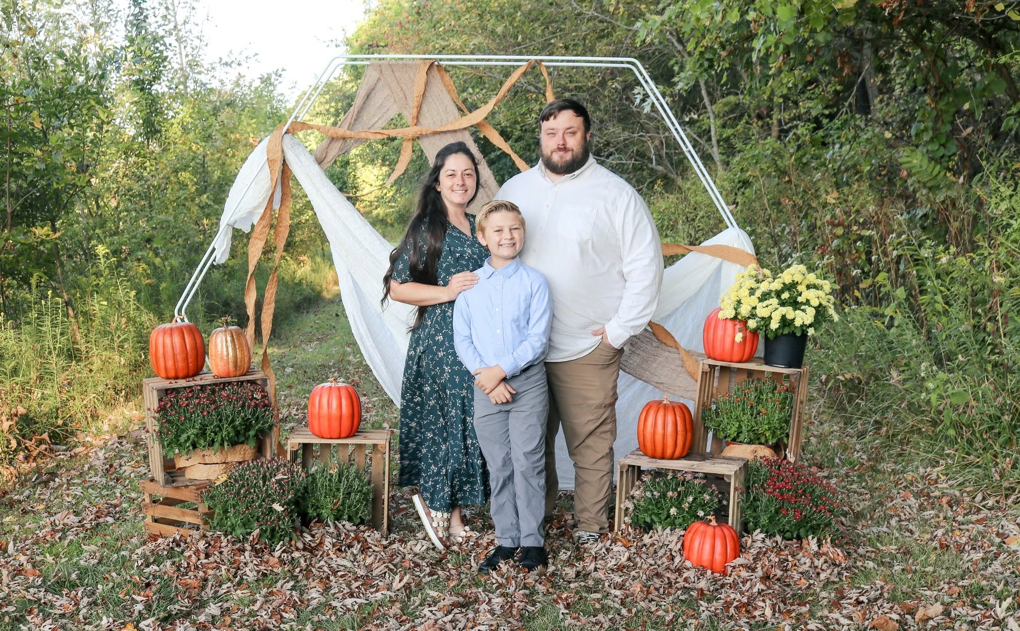 Cody, Brittnee, and Eli Woods together in a family photo for Wild Mountain Woodworks.